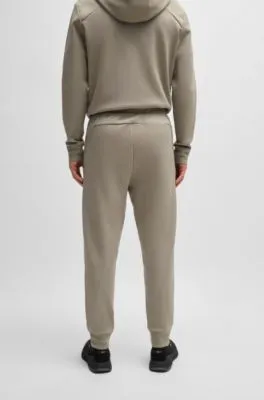 Tracksuit bottoms with mirror-effect logo