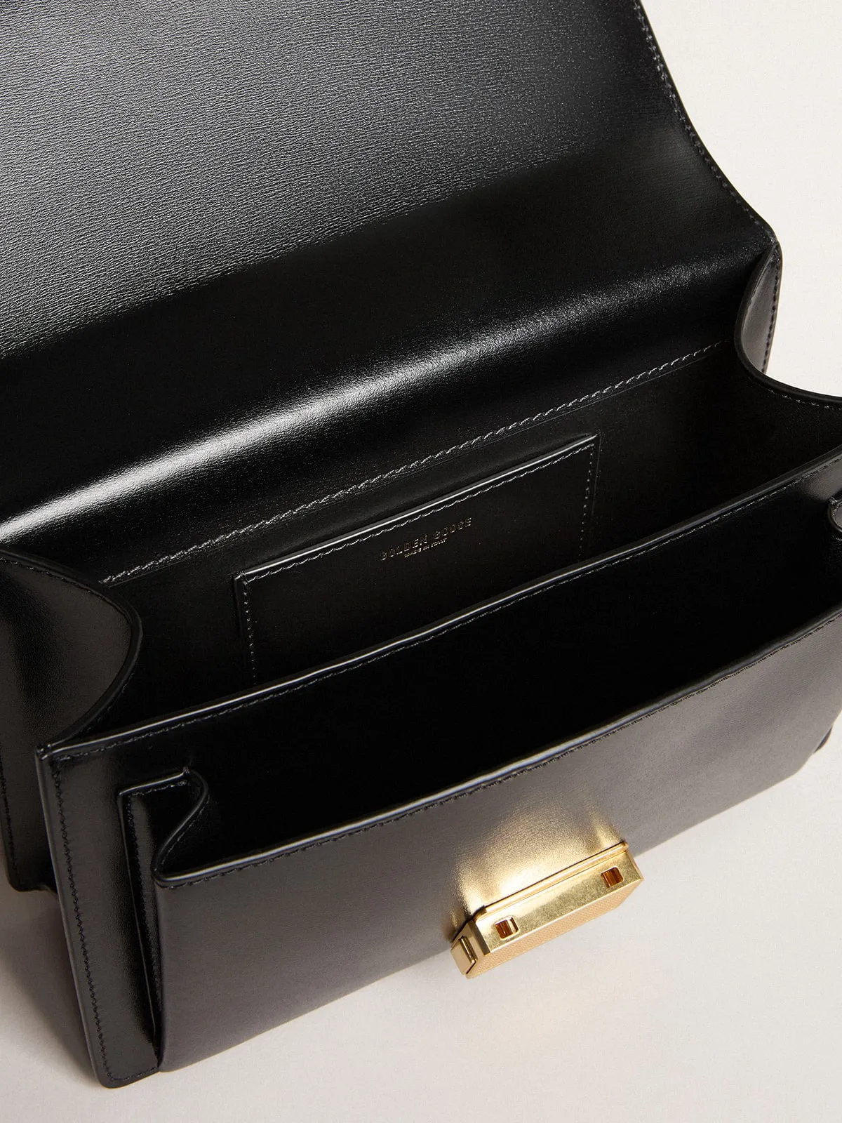 Venezia Bag in black boarded leather with gold details